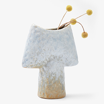 Styled product photograph of a light blue ceramic vase holding three dried yellow billy button flowers, positioned on a clean white background.