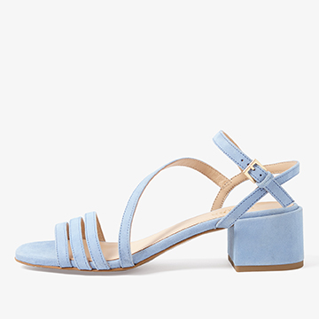 Side profile commercial product photograph of a light blue strappy sandal showing the block heel height and sole construction.